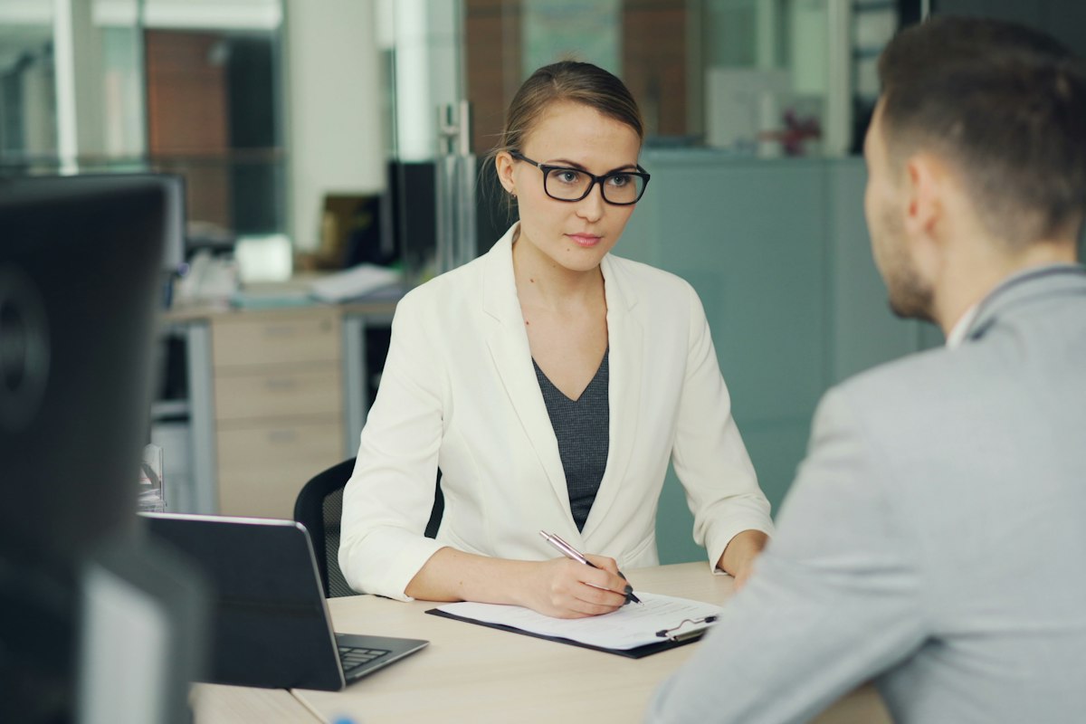 An adviser meeting a customer across a desk