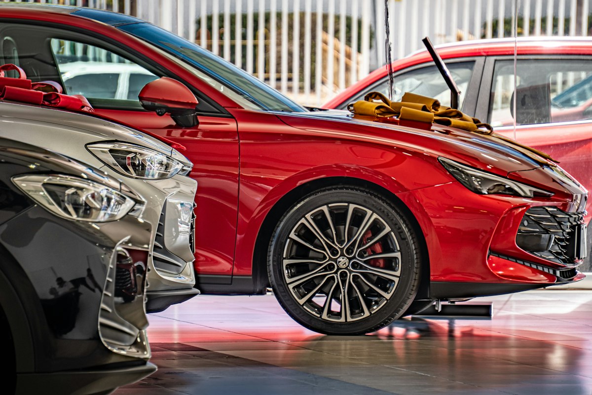 New cars lined up in a dealership showroom