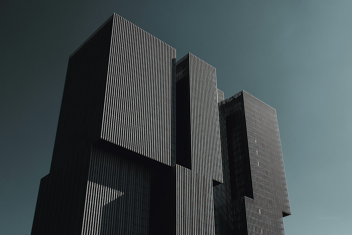 A dark modern office tower against the sky