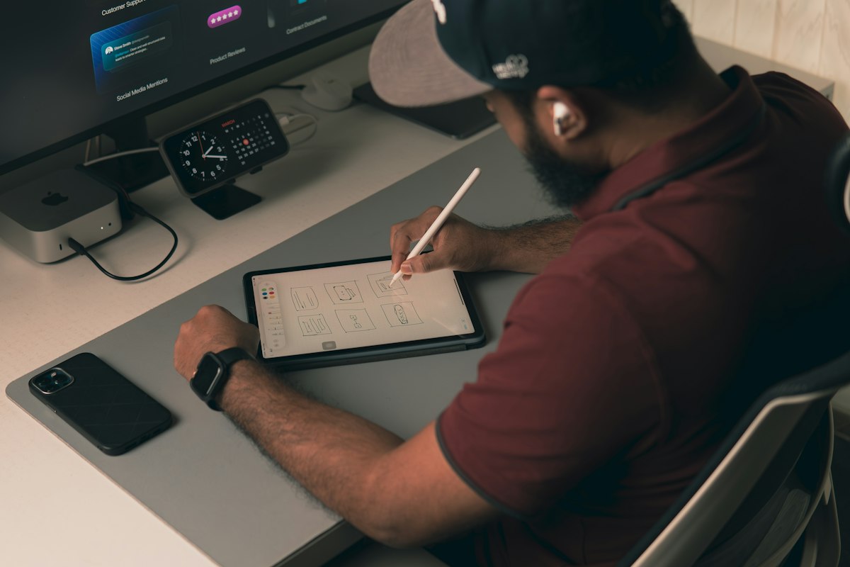 A designer sketching an interface on a tablet