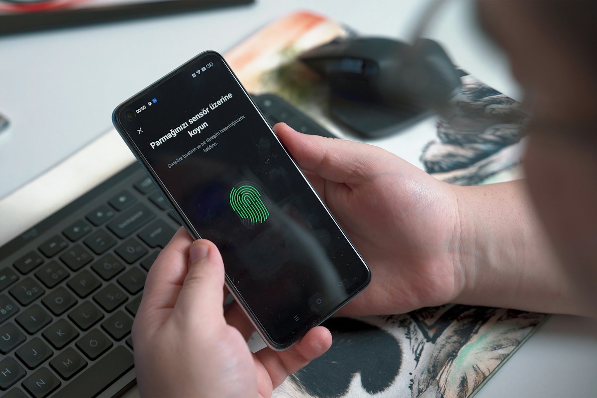 A person signing in to a phone with a fingerprint