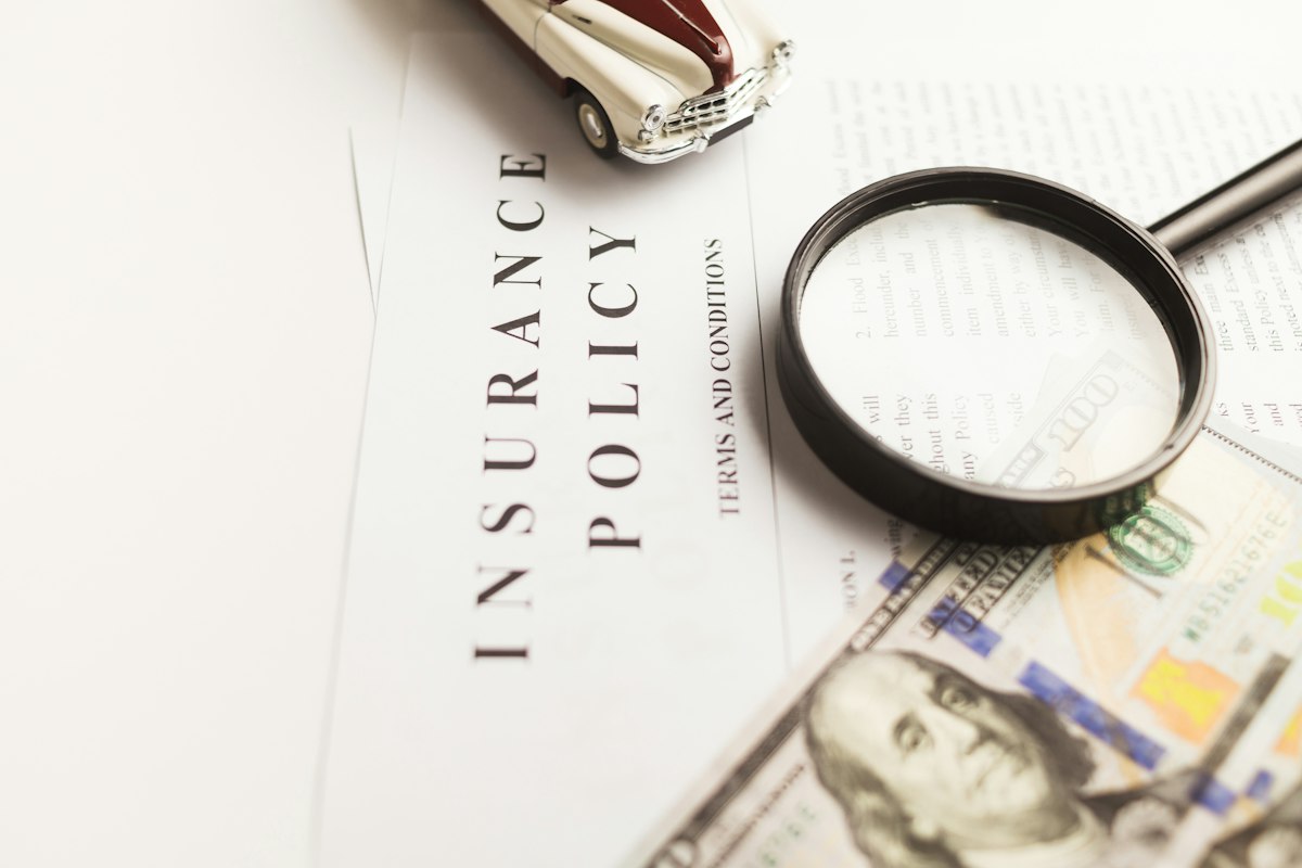 An insurance policy document under a magnifying glass