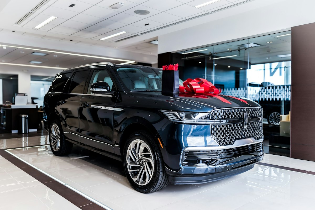 A new SUV with a bow on its bonnet in a showroom